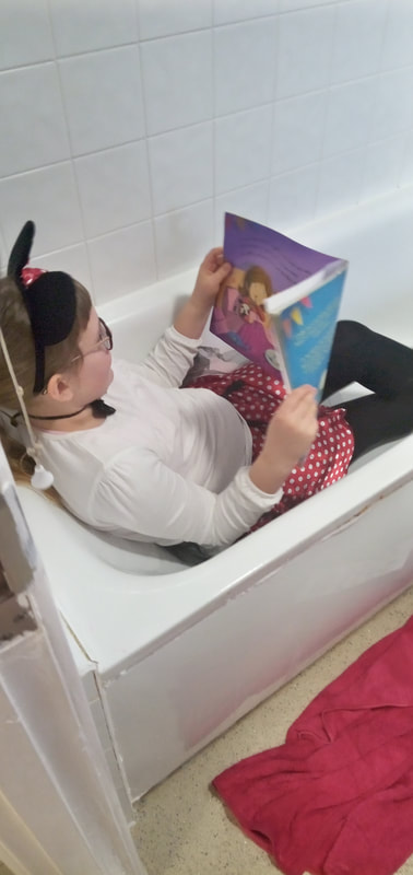 Victoria busy reading in the bath!